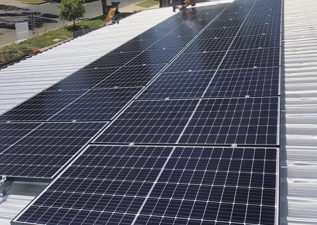 Completed rooftop solar array overlooking the neighbourhood