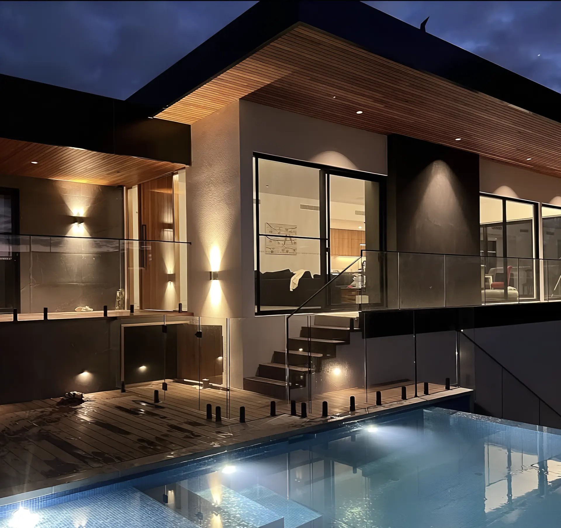 Completed architectural exterior and pool lighting at dusk