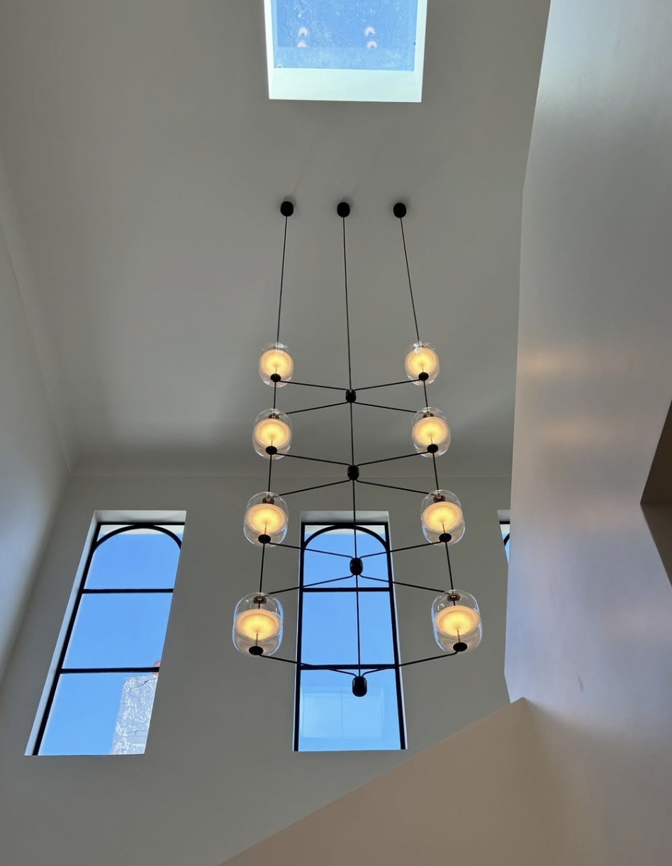 Completed multi-pendant lighting in a residential stairwell